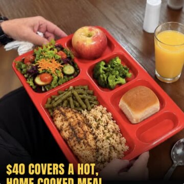 A red tray with salad, green beans, rice, fruit and a roll, with the headline $40 covers a hot, home-cooked meal