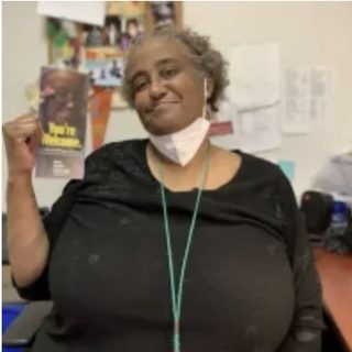 Portrait of Naimah O’Neal raising her fist